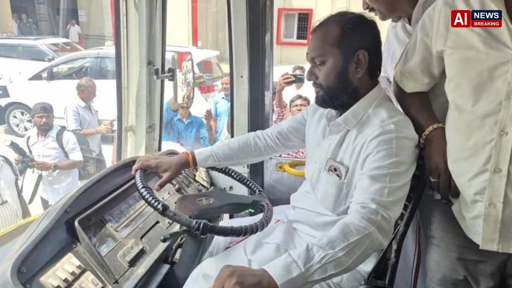 MLA sits in driver seat during bus launch ceremony.