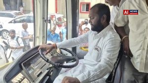 MLA sits in driver seat during bus launch ceremony.